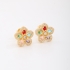 BX-0102 BRINCO BANHADO A OURO 18K DE FLOR COM DETALHES CRAVEJADOS EM ZIRCÔNIAS E PEDRAS