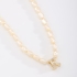 GR-02101 COLAR BANHADO A OURO 18K COM PÉROLAS BARROCAS E PINGENTE DE LETRA CRAVEJADO EM ZIRCÔNIAS