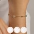 PI-00094 PULSEIRA INFANTIL BANHADA A OURO 18K COM DETALHES EM PÉROLA E PEDRAS COLORIDAS