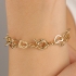 PU-00112 PULSEIRA COM ELOS ENTRELAÇADOS EM CORAÇÃO