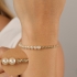 PU-00542 PULSEIRA BANHADA A OURO 18K COM CORRENTE TORCIDA E DETALHES EM PÉROLAS