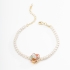 PU-00559 PULSEIRA COM DETALHES EM PÉROLAS E PINGENTE DE FLOR COLORIDA