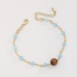 PU-00784 PULSEIRA COM CONTAS AZUL CLARO E DETALHE CENTRAL EM PEDRA NATURAL