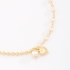 PU-00873 PULSEIRA COM PINGENTES DE PÉROLA E CORAÇÃO