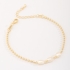 PU-00879 PULSEIRA COM DETALHES EM PÉROLAS E ESFERAS