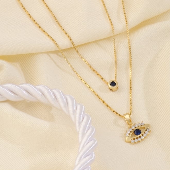 GR-00625 COLAR DUPLO BANHADO A OURO 18K COM CORRENTES VENEZIANAS, SENDO UMA COM PONTO DE LUZ EM ZIRCÔNIA E OUTRA COM OLHO GREGO