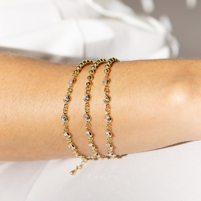 PU-00950 PULSEIRA BANHADA A OURO 18K COM DESIGN ASSIMÉTRICO DE ESFERAS E ZIRCÔNIAS